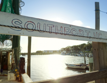 painted sign that says southport, nc