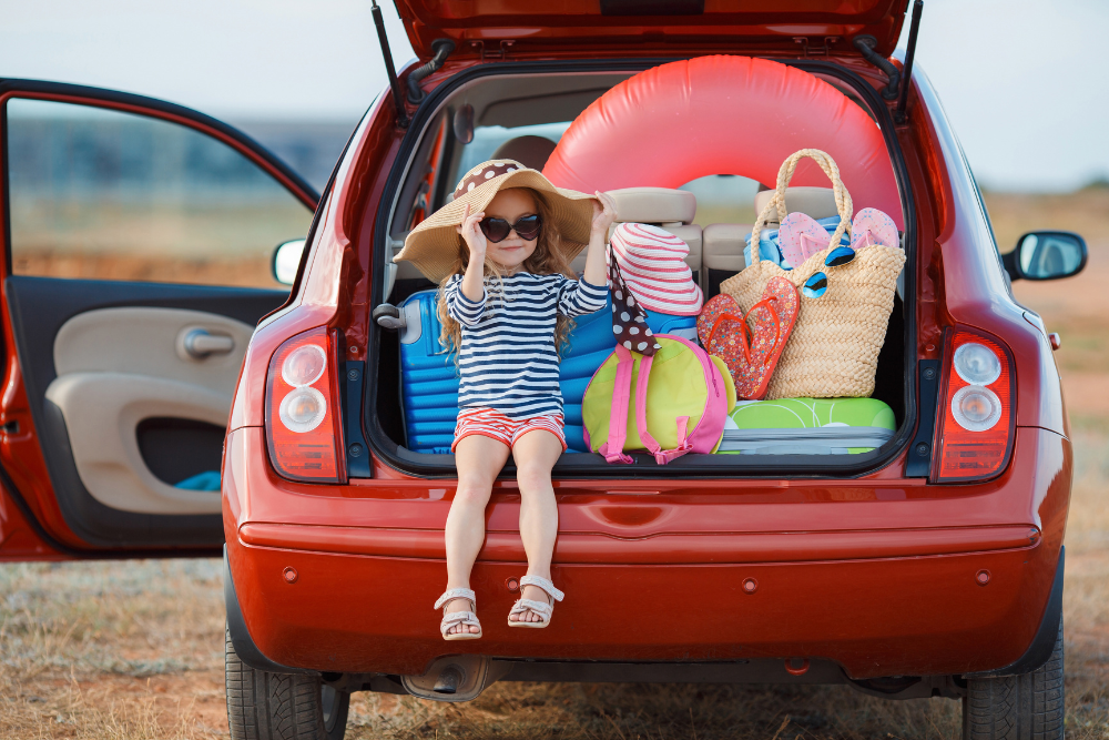car packed for beach vacation with child
