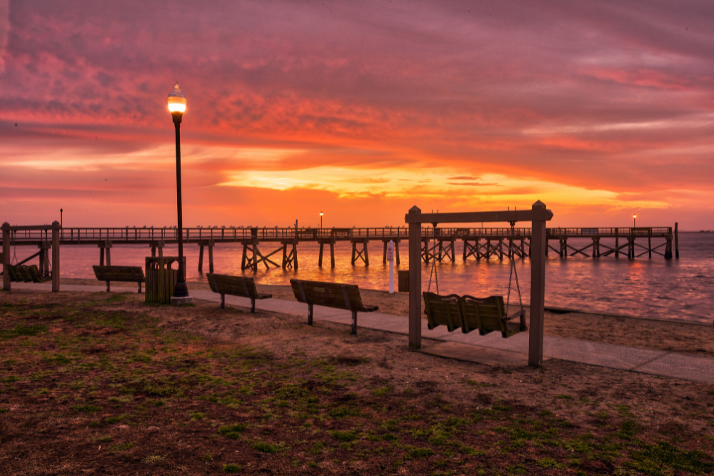 waterfront park with pier at sunset