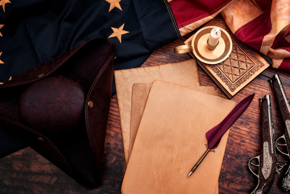 Colonial Documents with hat and feather on desk